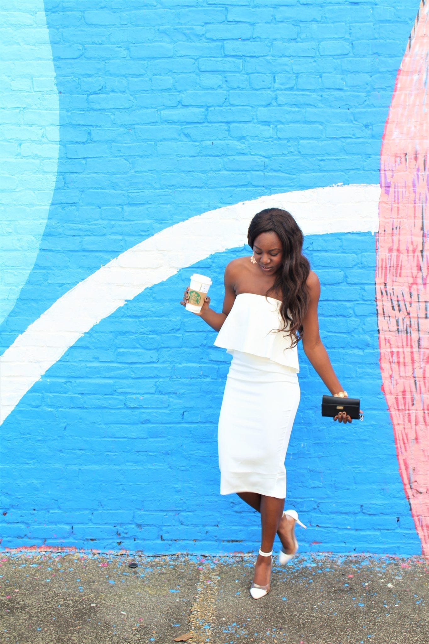 Tomi Obebe is wearing a white Missguided dress