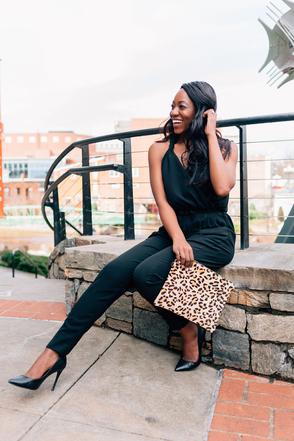 The black jumpsuit that works for day and night style- on the blog. | Leopard print clutch | Downtown Greenville