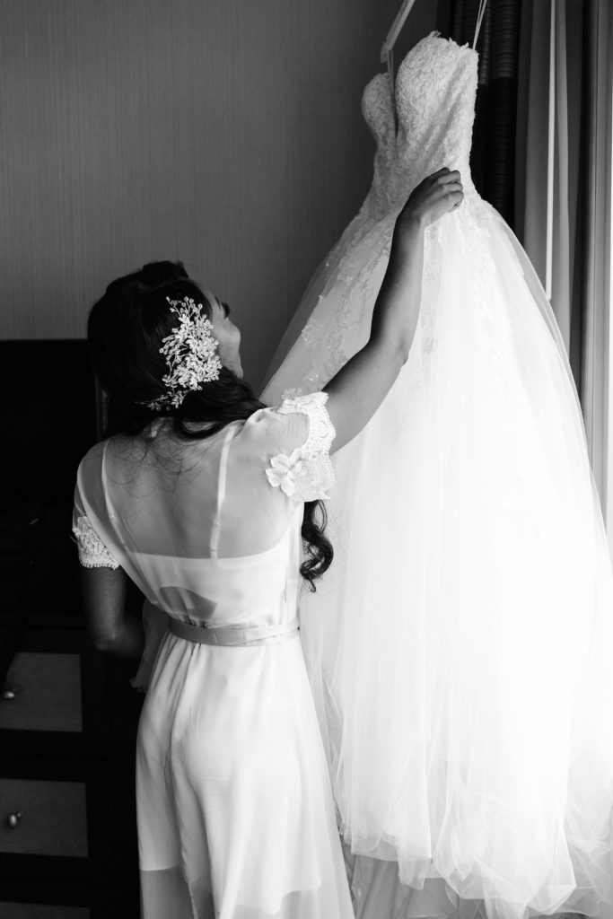 Black and white photo of bride in getting ready robe by BHLDN