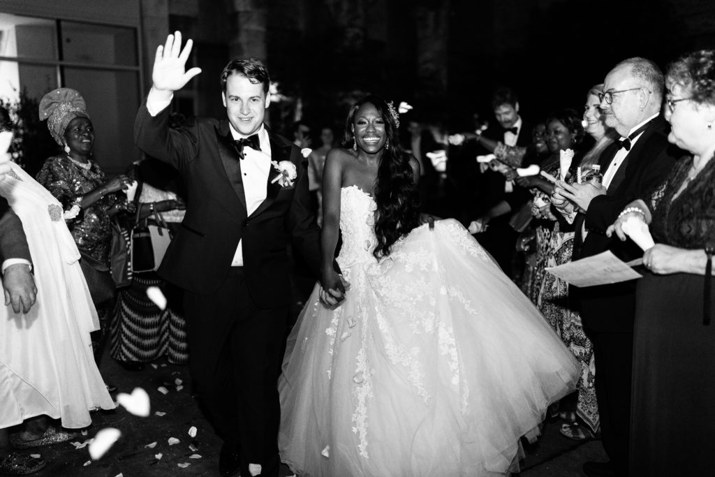 Black and white photo of the bride and groom wedding exit with confetti and flower petals | Full wedding details on GoodTomiCha.com