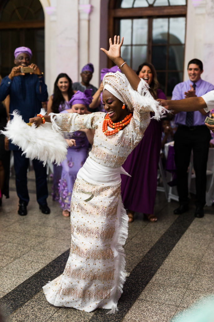 The bride takes the dance floor in her traditional nigerian outfit