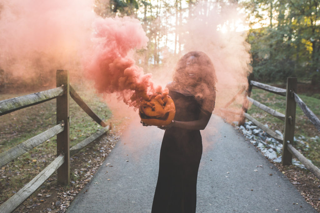 American style blogger covered in orange smoke from pumpkin photoshoot | October editorial ideas | Goodtomicha.com