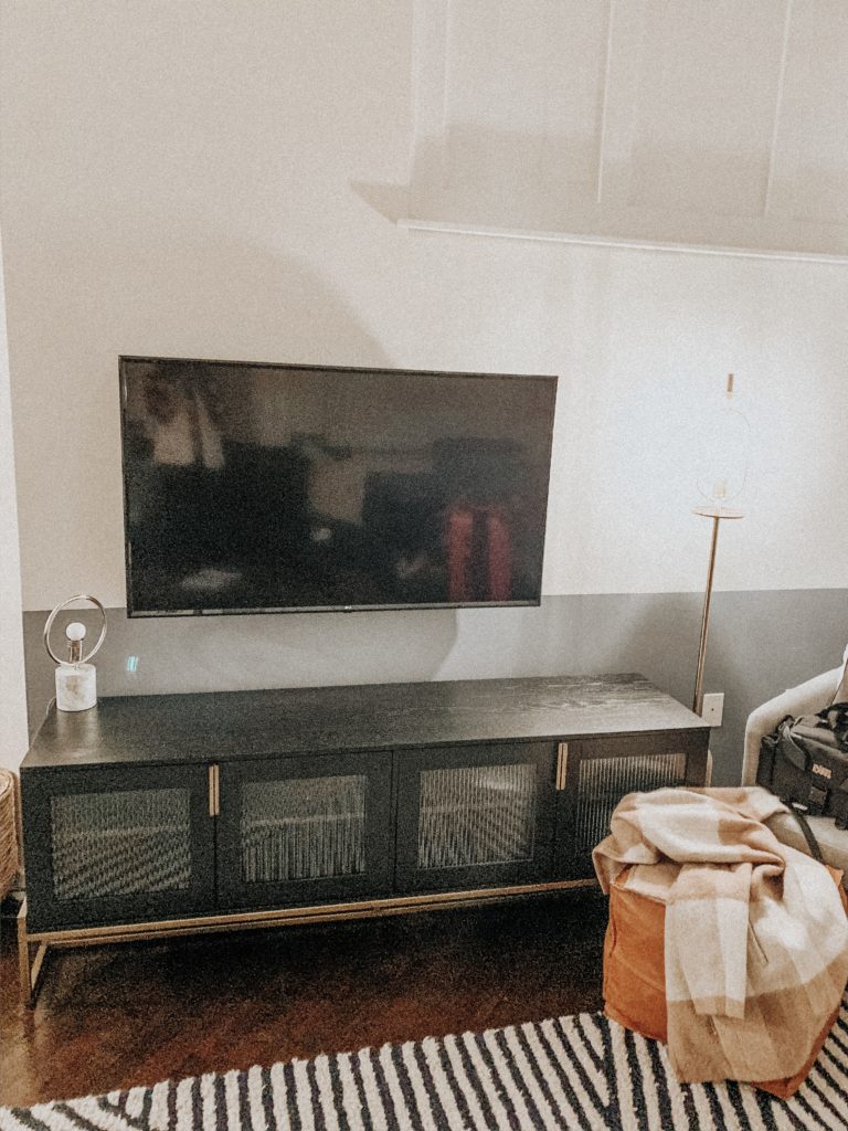 West Elm inspired decor with black credenza and mounted flat screen tv, modern standing lamp
