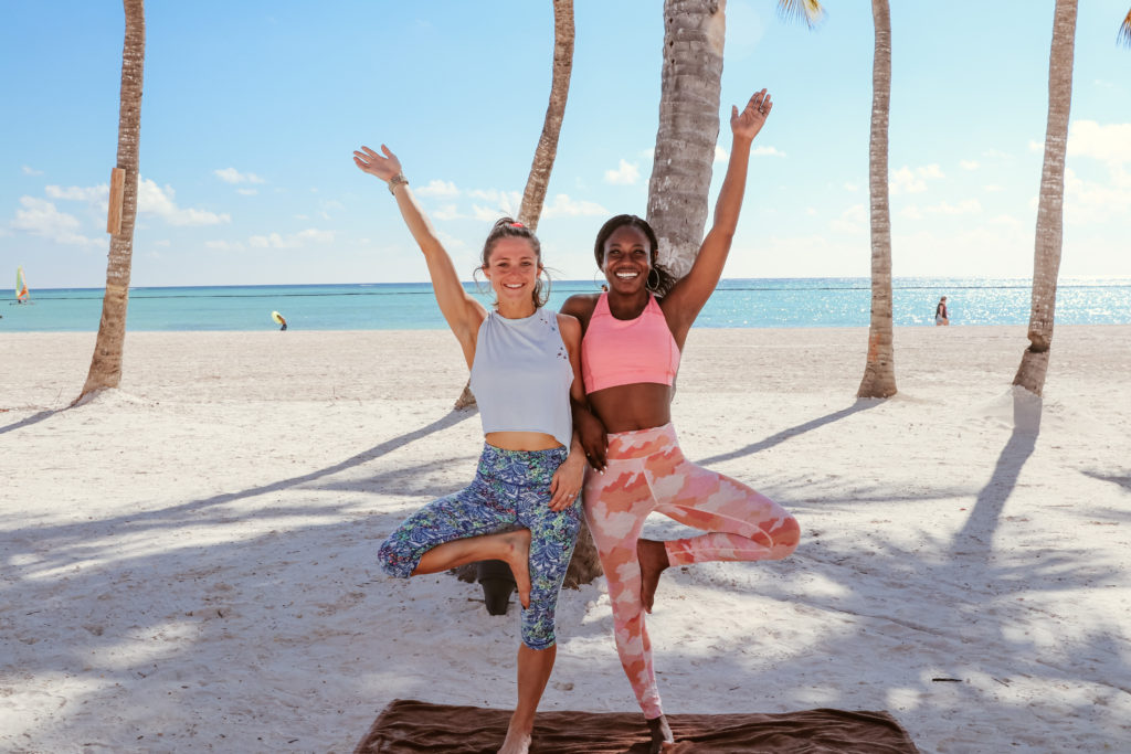 2 young women posing for a yoga class on the beaches of Punta Cana in hyatt zilara cap cana 
