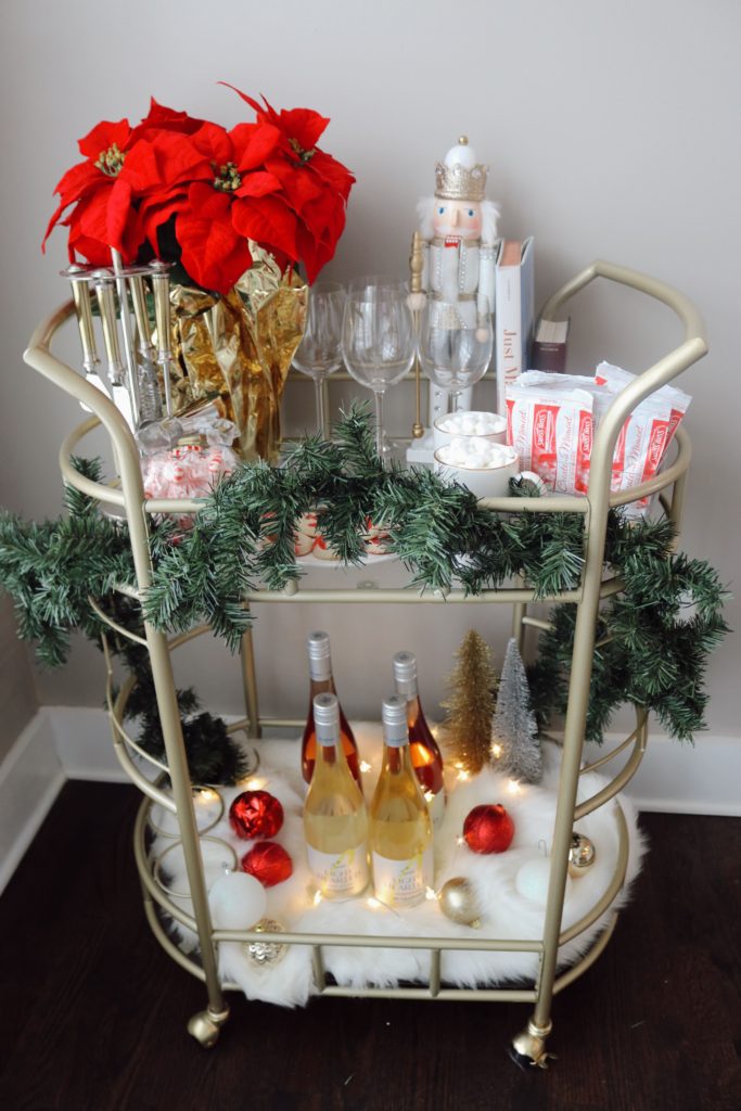how to style holiday bar cart with decorations, glasses, and wine