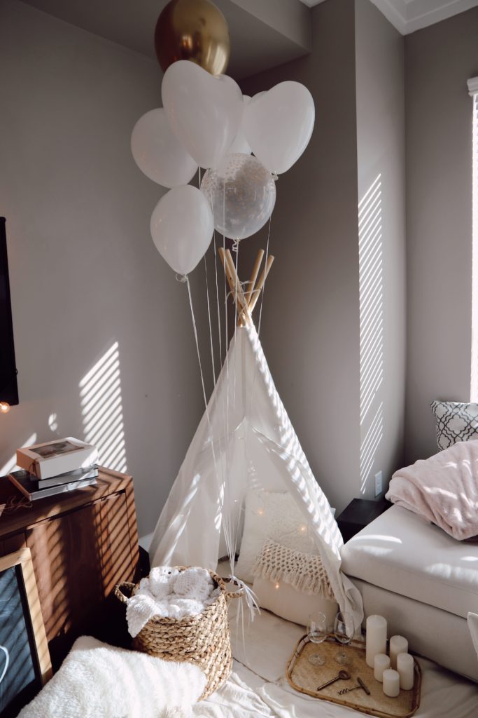 ideas for date night at home with DIY tent, balloons, and candles 