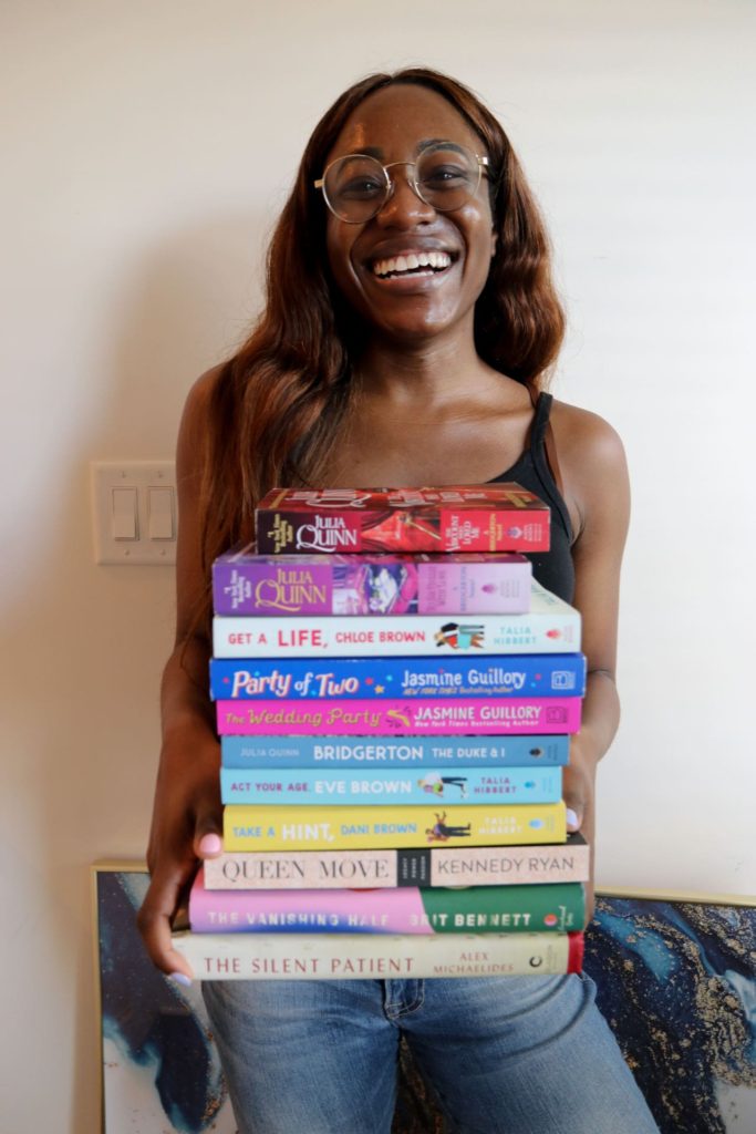 woman holding books for Q1 book review 2021