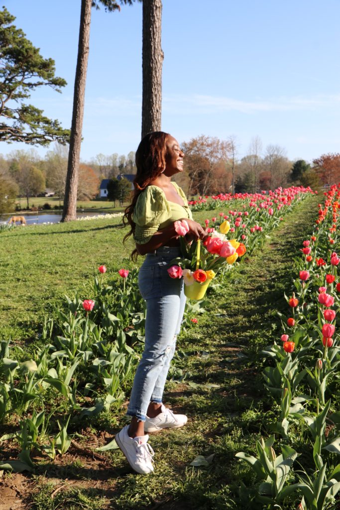 woman picking flowers at Dewberry Farms Spring 