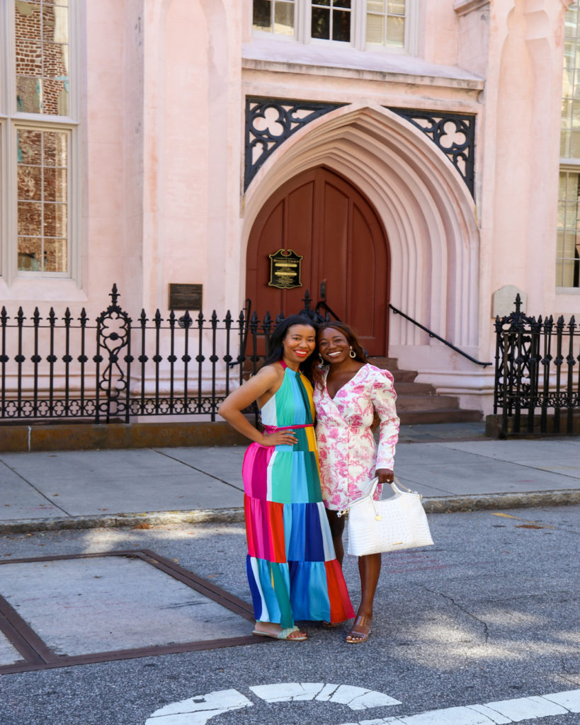 two women smiling outside a church