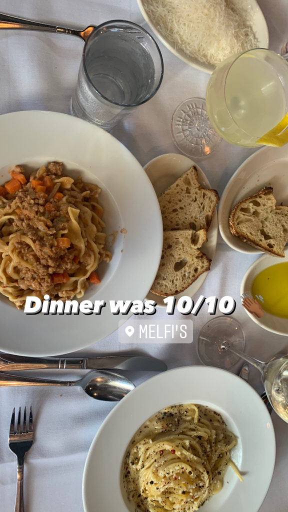 pasta meals, bread, and drinks on a table for Charleston Trip Recap