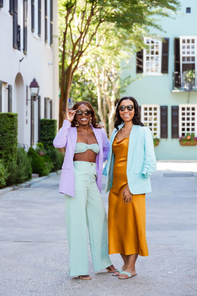 two women wearing pastel clothes and sunglasses 