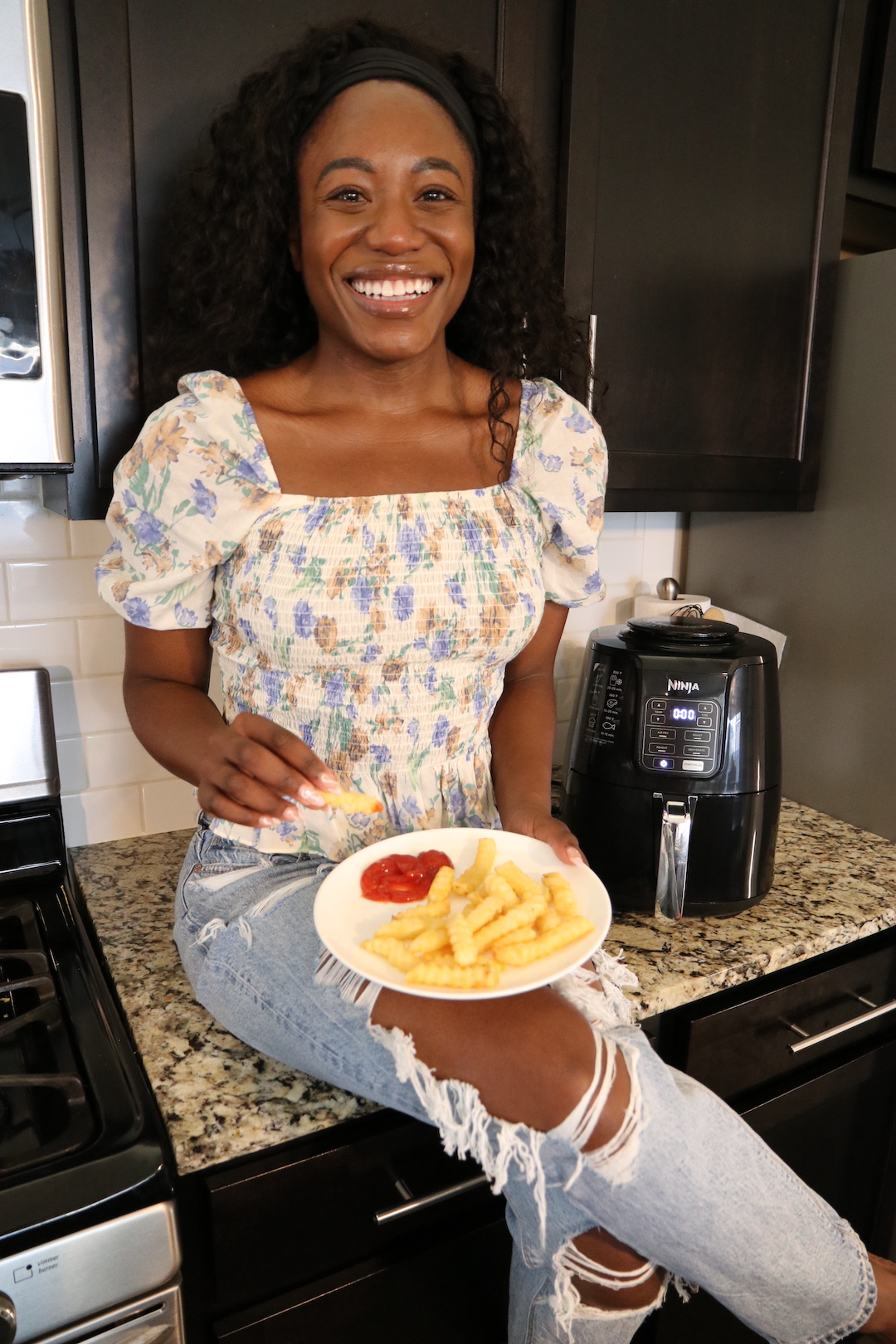 woman holding a plate with air fried food 