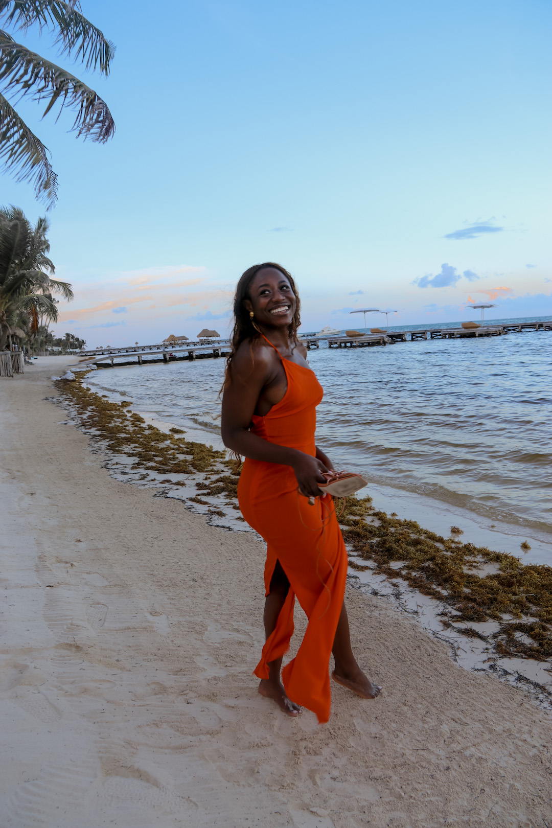 woman in an orange dress at the shore