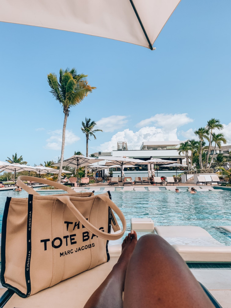 woman laying by pool in Jamaica featuring a tote bag