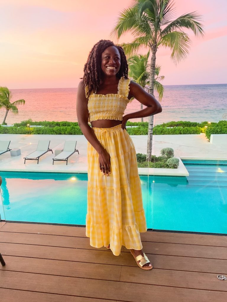 goodtomicha wearing a two-piece gingham set in front of pool and ocean in Jamaica