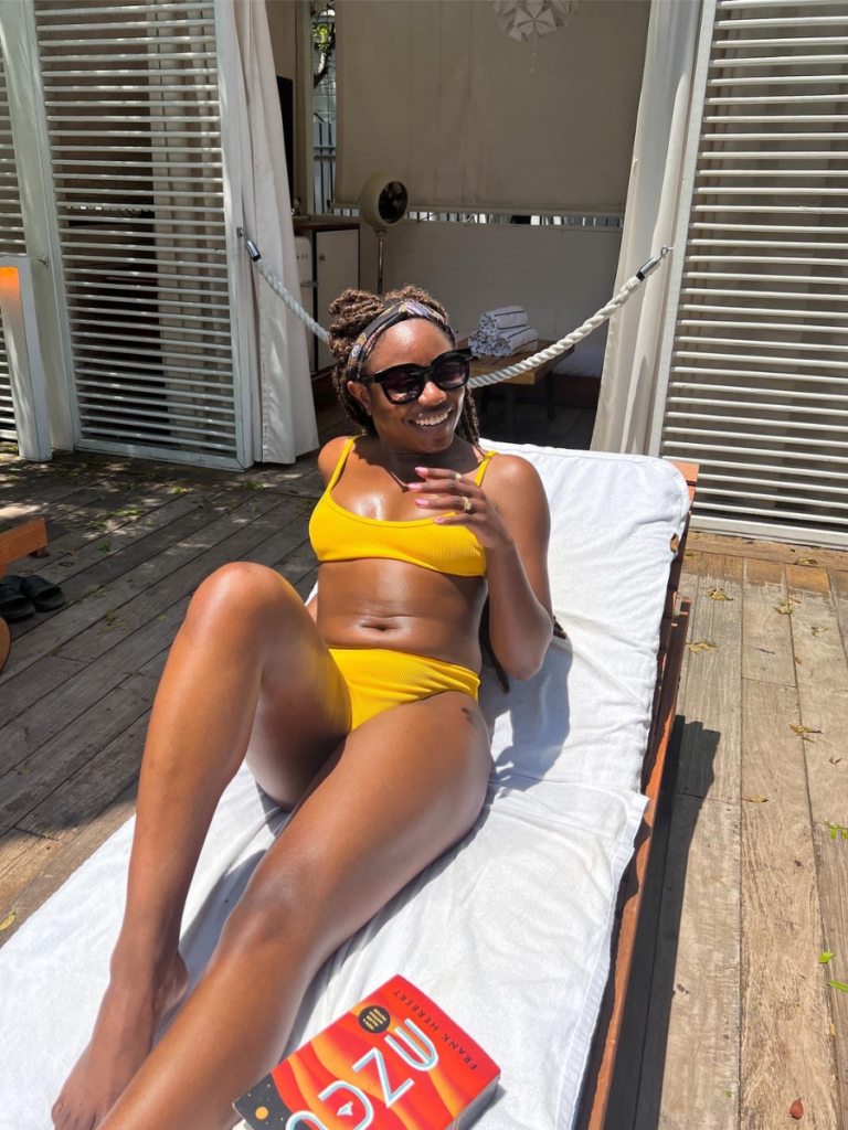 goodtomicha laying out sunbathing in yellow swimsuit