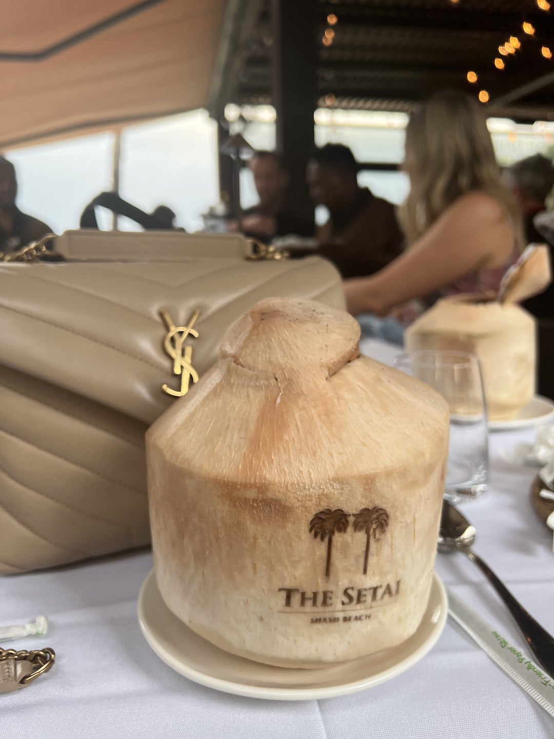The Setai Miami - coconut drink in front of YSL bag