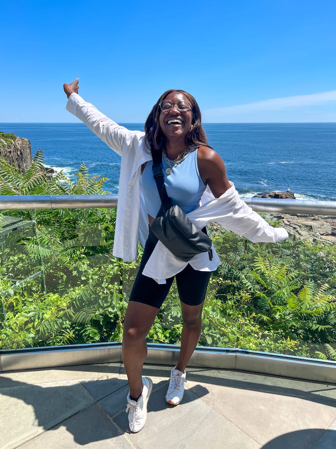 woman in Maine wearing bike shorts, belt bag and white button down