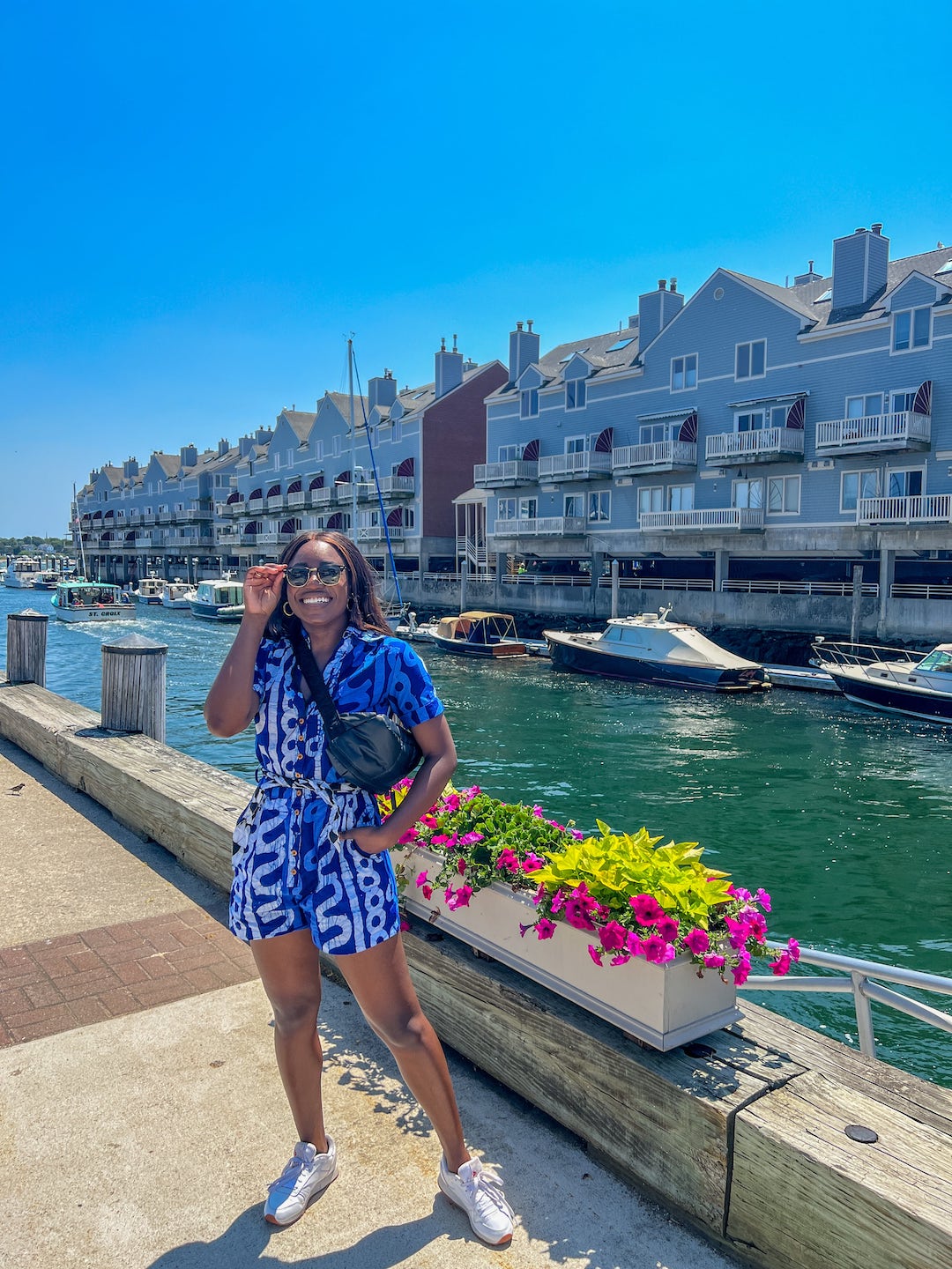 woman posing in front of docks in Maine