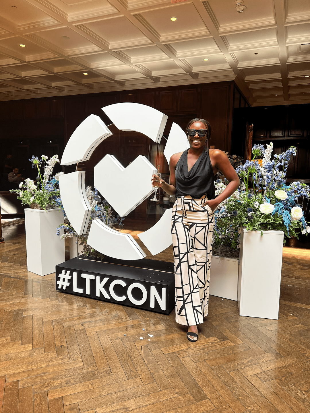 goodtomicha in front of the #LTKCON sign at LTK Conference
