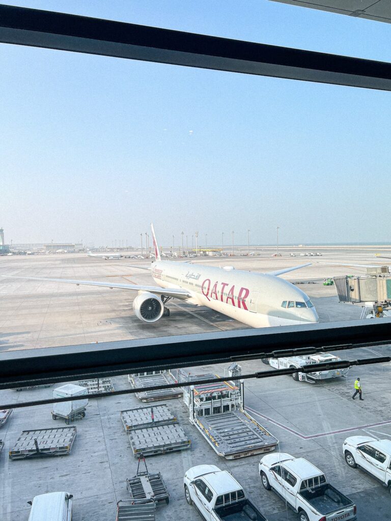 view of Qatar airplane from airport window