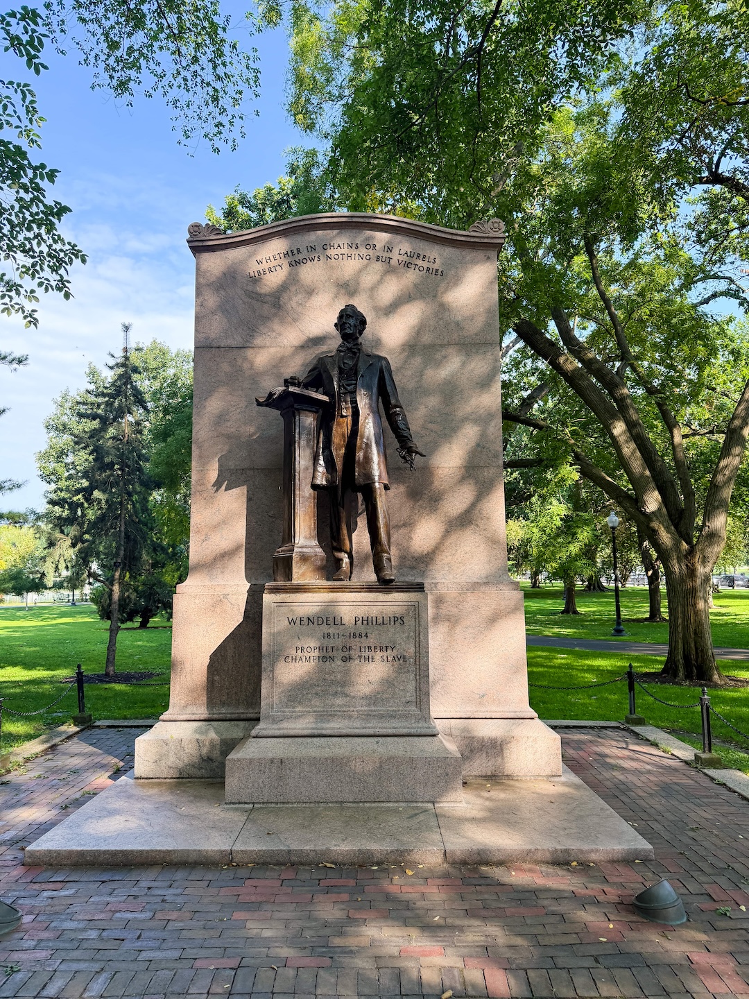 Boston Public Garden pond with swan boats and willow trees in the background | free things to do in boston on goodtomicha.com